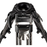 Close-up of a tripod head and lower legs, showing a black quick-release tripod head with the Libec brand name and TK-2100C text, and dark carbon-fiber legs on a white background.