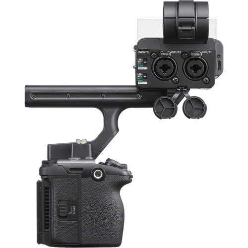 A black camera accessory setup featuring a handheld gimbal handle connected to a camera body, with an additional mounted control module and two small round caps, shown on a plain white background.