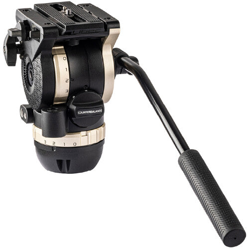 A black and gold Cinema Gold fluid head for cameras, featuring a long black handle with a textured grip, shown on a solid white background.