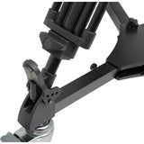 Black adjustable tripod stand on a white background