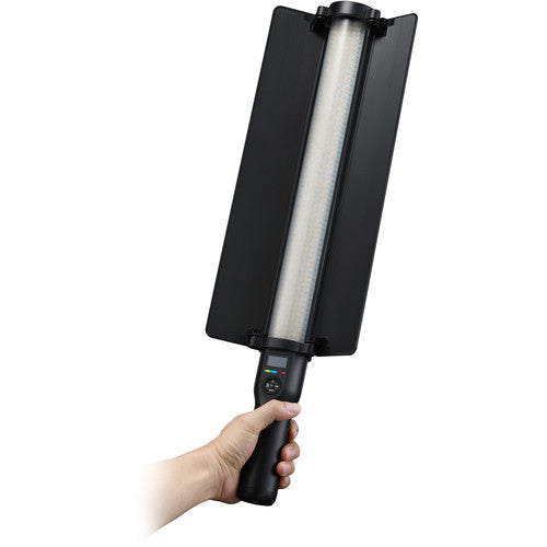 Hand holding a black and silver cleaning brush on a white background