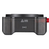 Black electronic device with a red button on a white background