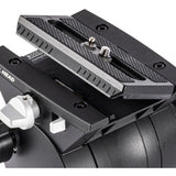 Close-up of a black camera mounting head with a quick-release plate, silver adjustment knobs, and a white release lever on a white background.