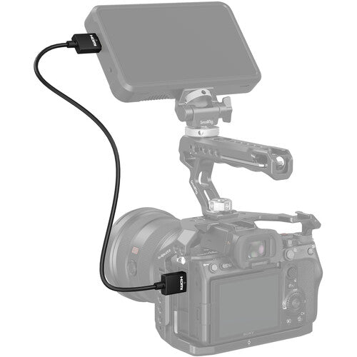 Camera with external monitor and cable on a white background
