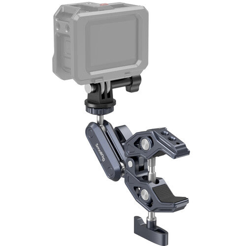 A dark gray and black adjustable camera mount clamp with a quick-release screw mechanism, shown holding a gray action camera against a plain white background.