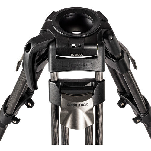 Close-up of a tripod head and lower legs, showing a black quick-release tripod head with the Libec brand name and TK-2100C text, and dark carbon-fiber legs on a white background.