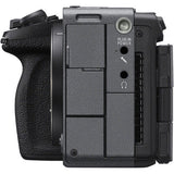 Close-up of the side and back of a black camera body with grip, power plug-in ports, and connector details on a white background.