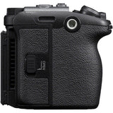 Close-up of the textured black grip and side panel of a camera body, showing a textured leather-like finish, control buttons, and an 'OPEN' switch on a plain white background.