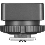 Camera lens cap with a black body and silver base on a white background