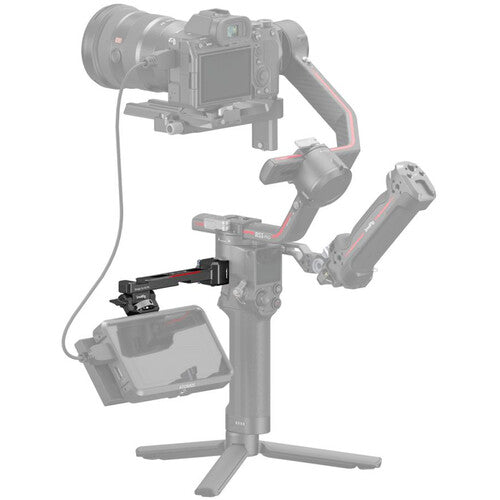A gimbal camera accessory setup shown on a white background, featuring a camera mounted on a three-legged tripod-style gimbal with an additional monitor mount and cable attached.