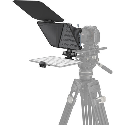 Video camera with teleprompter on a tripod against a white background