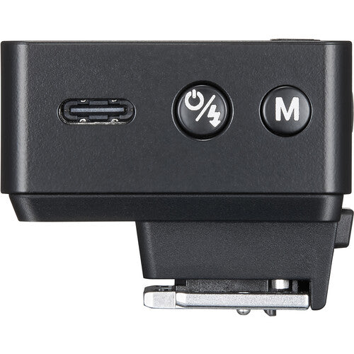Black camera flash unit with power and mode buttons on a white background