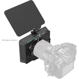 Camera with a lens hood and 360-degree rotation feature on a white background