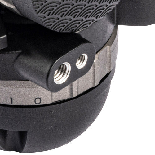 Close-up detail of a black camera tripod base with threaded mounting holes and a textured rubber foot on a white background.