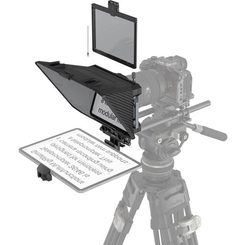 Camera on a tripod with various accessories including a screen and a modular panel.