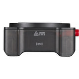Black electronic device with a red button on a white background