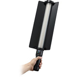 Hand holding a black and silver cleaning brush on a white background