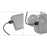 Camera with HDMI cable attached to a device, on a white background