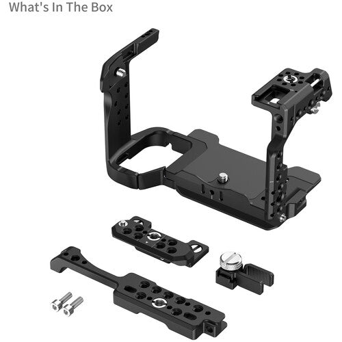 Black camera grip attachment kit with mounting plates, screws, and a thumbscrew on a white background, with 'What's In The Box' text in the top left corner.