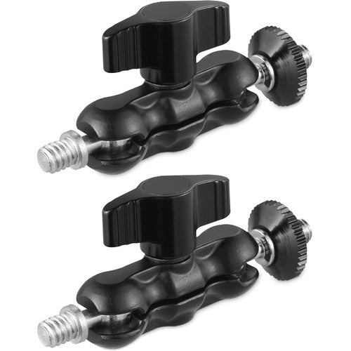 Two black camera tripods with adjustable arms on a white background