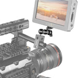 Camera with monitor displaying a scenic view of deer in a field, mounted on a stabilizing rig.