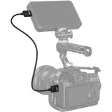 Camera with external monitor and cable on a white background