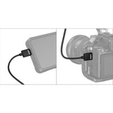Camera with HDMI cable attached to a device, on a white background